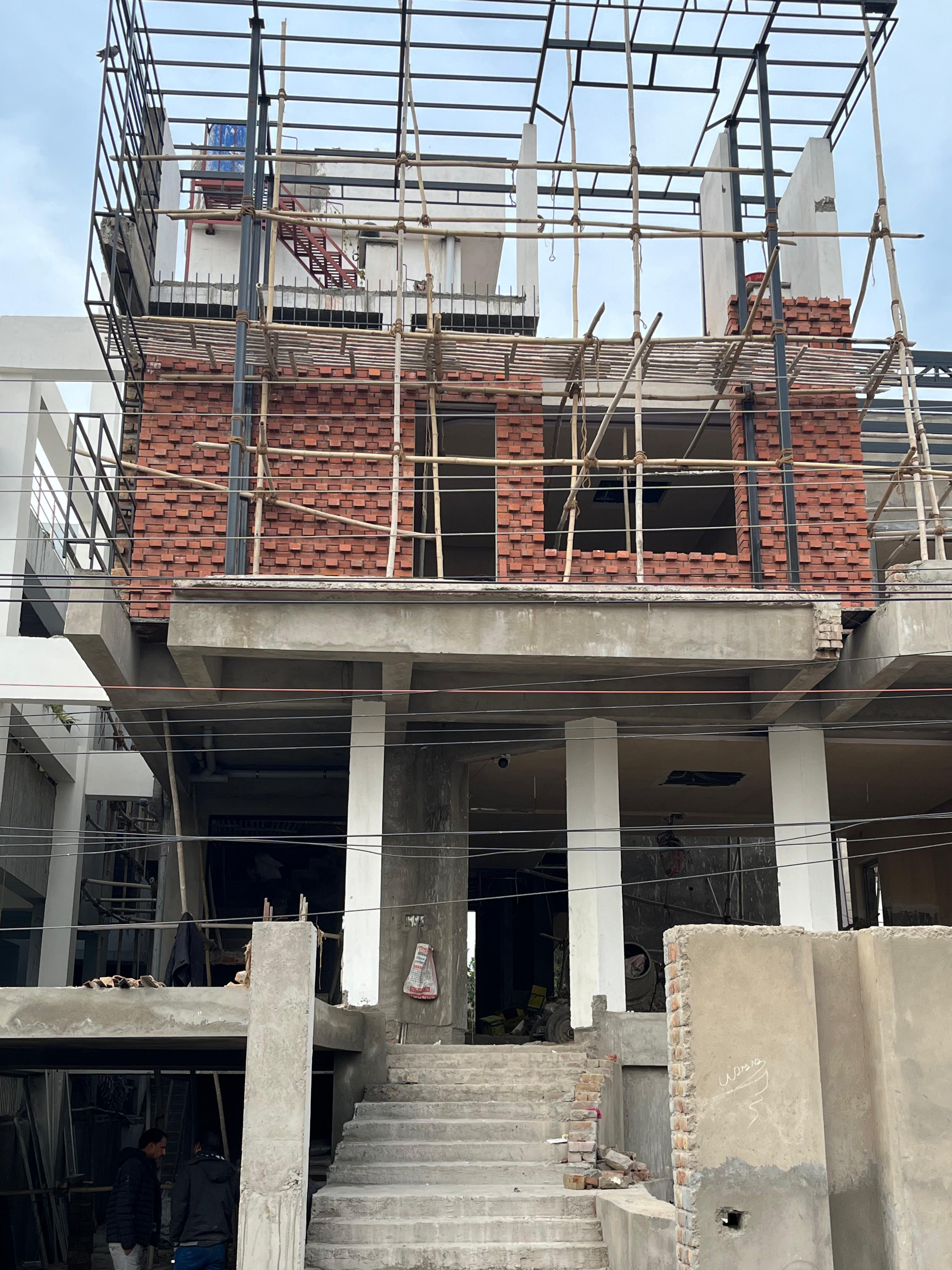 Commercial building under construction with wire cut bricks — Bricks Street